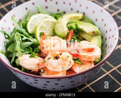 Salad of prawns. Salad of shrimps, arugula, avocado slice, close up. Healthy concept. Stock Photo