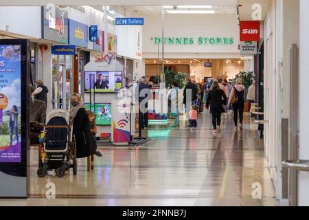 Cork, Ireland. 18th May, 2021. Shoppers in Blackpool Shopping Centre, Cork, Ireland. A large number of shoppers took to Blackpool Shopping Centre and Retail Park this morning enjoying the reopening of non-essential retail stores yesterday. There was a lively atmosphere throughout the centre shoppers went from shop to shop with the occasional stop to chat with friends and neighbours in the community. Credit: Damian Coleman/Alamy Live News Stock Photo