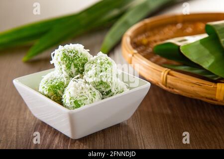 Ondeh ondeh is a traditional Malay snack made of rice ball filled with brown sugar, coated in grated coconut. Stock Photo