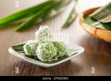 Ondeh ondeh is a traditional Malay snack made of rice ball filled with brown sugar, coated in grated coconut. Stock Photo