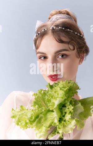Young woman in art action isolated on white background. Retro style, comparison of eras concept. Stock Photo