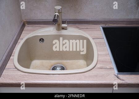 Beige clean kitchen sink with faucet for drinking water Stock Photo