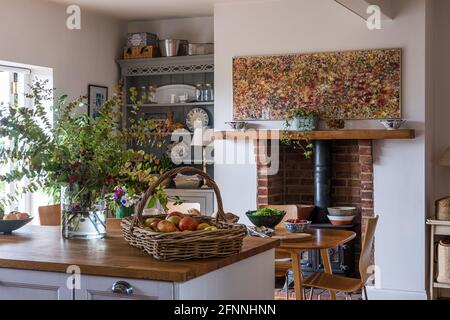 Modern art and basket of apples in 19th century Victorian cottage. Stock Photo