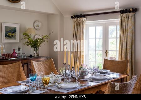 Wicker chairs at dining table in 19th century Victorian cottage. Stock Photo