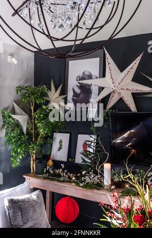 Prints and decorations on black wall in Georgian cottage, West Sussex. Stock Photo