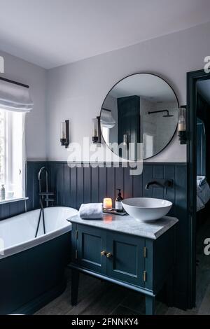 Large mirror above wash stand in bathroom of Georgian cottage, West Sussex. Stock Photo