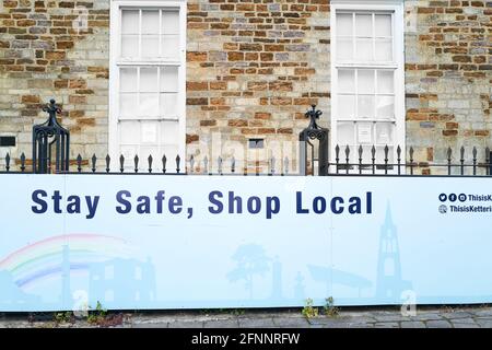 'Stay safe, stay local' notice at the market place, Kettering, England, during the coronavirus epidemic, april 2021. Stock Photo