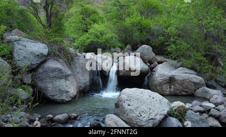 beautiful waterfall among the huge rocks in forest. beautiful nature ...