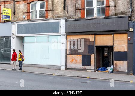 Closed down and boarded up shops in Crouch End, one a Starbucks Coffee shop, London, UK Stock Photo