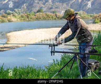 man preparing fishing equipment for a carp fishing session on the rive  Stock Photo - Alamy