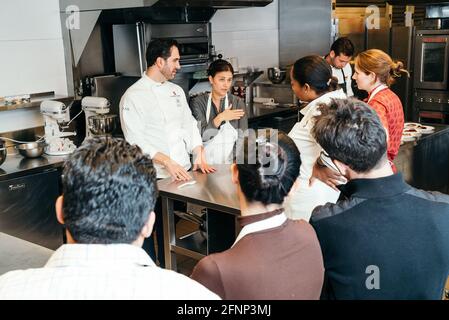 A Journey into Spain’s Food and Culture - Suckling Pig Master Class Led by Chef Mario Sandoval, at the Kitchen Classroom of ICE Stock Photo