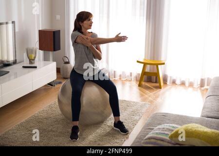 Woman doing exercise at home Stock Photo