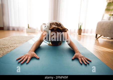 Woman doing exercise at home Stock Photo