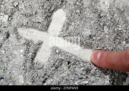 Cross made of ashes. Ash Wednesday. Lent season. France. Stock Photo