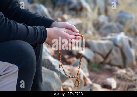 Pilgrim praying on top of the the hill of apparitions, Podbrdo, Medjugorje, Bosnia and Herzegovina Stock Photo