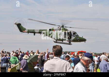 British Army, Army Air Corps Westland Lynx AH.7 helicopter ZD284 departing at Royal International Air Tattoo, RIAT, RAF Fairford, UK. Crowd waving Stock Photo