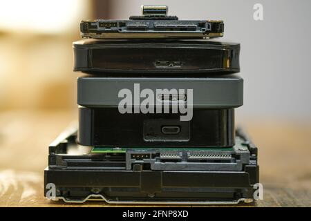 Satck of hdd memory storage devices over dark surface,tech components,usb,memory Stock Photo