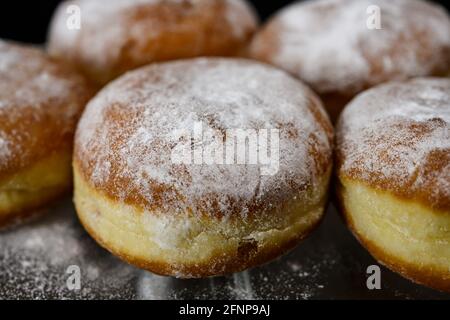 Chocolate or jelly filled donuts sprinkled with powder sugar Stock Photo