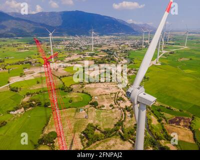 Wind turbine being repaired, assisted by crane and elevator. Wind power plant. green meadow with Wind turbines generating electricity Stock Photo