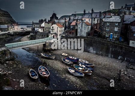 Staithes harbour with traditional cobble fishing boats Yorkshire 1979 Stock Photo