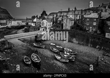 Staithes harbour with traditional cobble fishing boats Yorkshire 1979 Stock Photo