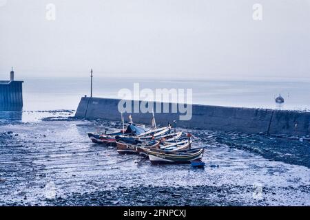 Staithes harbour with traditional cobble fishing boats Yorkshire 1979 Stock Photo