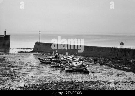 Staithes harbour with traditional cobble fishing boats Yorkshire 1979 Stock Photo