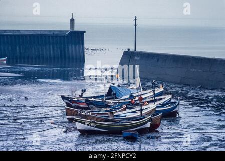 Staithes harbour with traditional cobble fishing boats Yorkshire 1979 Stock Photo