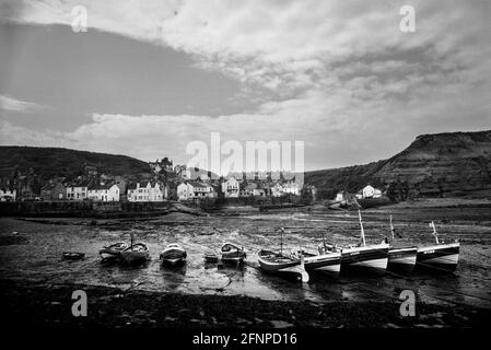 Staithes harbour with traditional cobble fishing boats Yorkshire 1979 Stock Photo