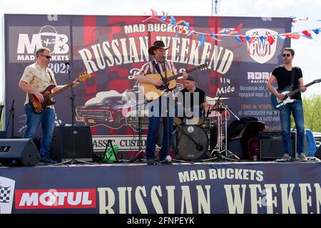 Moscow, Russia. 16th May, 2021. A musical group performs country music, during the event. The annual classic drag races of American retro cars from the Mad Buckets team took place at the RDRC Racepark Bykovo. Credit: SOPA Images Limited/Alamy Live News Stock Photo