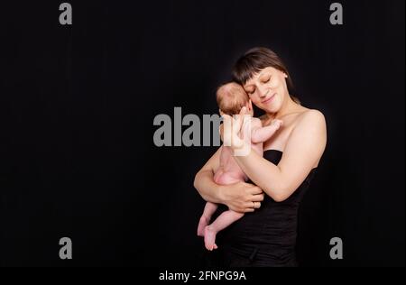 Happy mother with her baby boy. Loving mom carying of her newborn baby Stock Photo