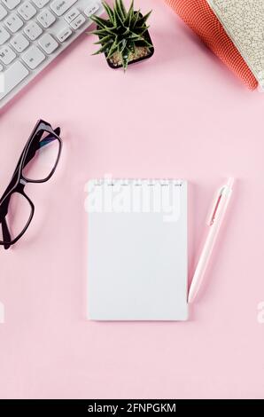 Back to school concept. Pencil case with school stationery on pink background. Keyboard, notebook paper, pencil, paper clip and sticky note with copy Stock Photo