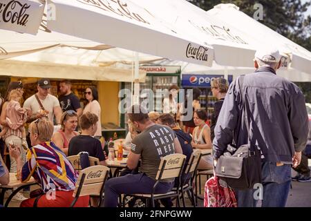 Kyiv, Ukraine - May 16: Opening of street cafes after quarantine. People relaxing on the terrace in sunny weather on Sunday. High quality photo Stock Photo