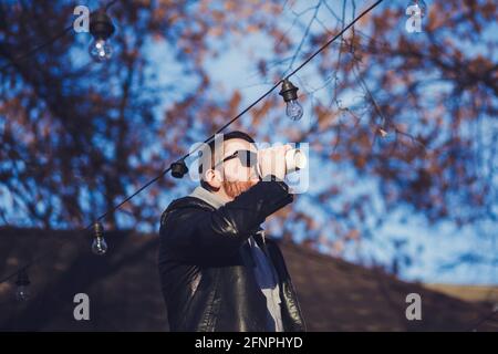 stylish bearded man in casual clothes drinking hot coffee Stock Photo