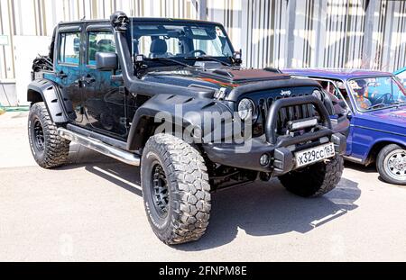 Samara, Russia - May 15, 2021: Tuned Jeep Wrangler vehicle at the city street. Black all terrain vehicle 4x4 Stock Photo