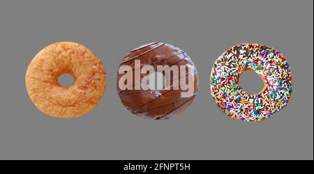 Three of Delectable Assorted Donuts Isolated on Gray Background Stock Photo