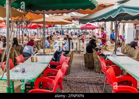 KUWAIT CITY, KUWAIT - MARCH 18, 2017: People eat in a food hall of the Souq market in Kuwait city. Stock Photo
