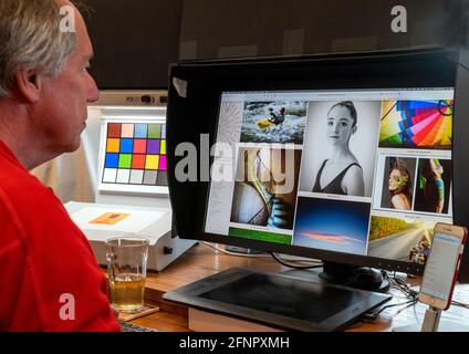 Photographer H. Mark Weidman viewing his web site on a large computer monitor Stock Photo