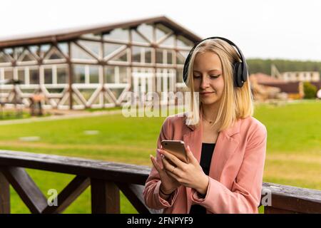 Portrait of a smiling lovely girl typing message on mobile phone in subway train Stock Photo