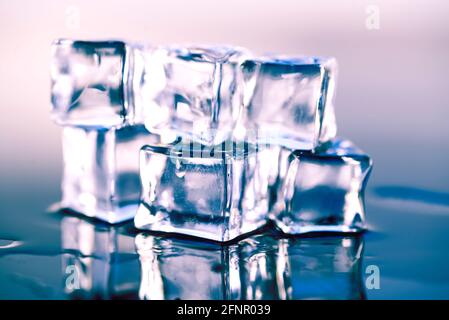 Wet ice cubes on gray background, close up Stock Photo