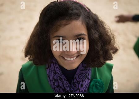 Uttar Pradesh, India. 05-11-2019.Portrait of a beautiful indian girl smiling and looking at the camera while attending school. Stock Photo