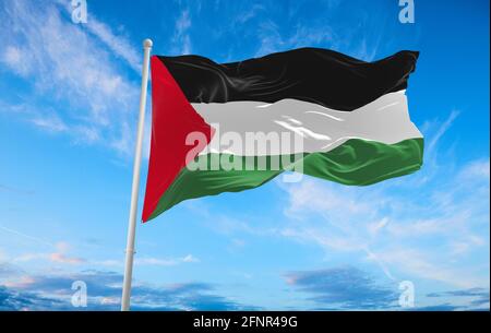 flag of palestine waving in the wind on flagpole against the sky with clouds on sunny day. 3d illustration Stock Photo