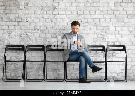 Worried job seeker waiting for interview far too long Stock Photo