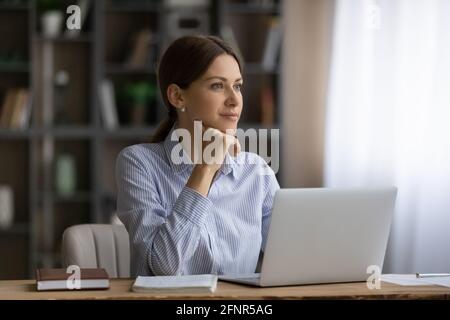 Ambitious female student dream of future profession distracted from pc Stock Photo