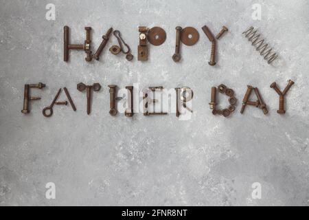 Word Father Day made of rusty hand tools which lie on a stone background Stock Photo