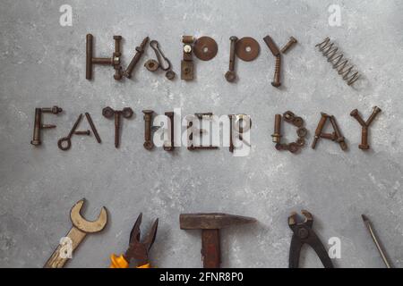 Word Father Day made of rusty hand tools which lie on a stone background Stock Photo