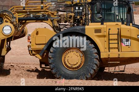 Huge tires on the cab of a Caterpillar 623H wheel-tractor scraper at a road construction site in Santa Fe, New Mexico. Stock Photo