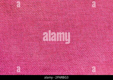 Close-up of red textile texture, red fabric for background and wallpaper. Stock Photo