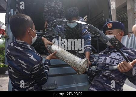 Denpasar, Indonesia. 18th May, 2021. Indonesian Navy officers carry parts of the sunken Indonesian Navy submarine KRI Nanggala-402 after a press conference in Denpasar, Bali, Indonesia, May 18, 2021. The Indonesian Navy, with the assistance of China's People's Liberation Army Navy, has managed to lift a life raft and other fragments belonging to the sunken Indonesian submarine KRI Nanggala-402 in the Bali waters. Credit: Bisinglasi/Xinhua/Alamy Live News Stock Photo