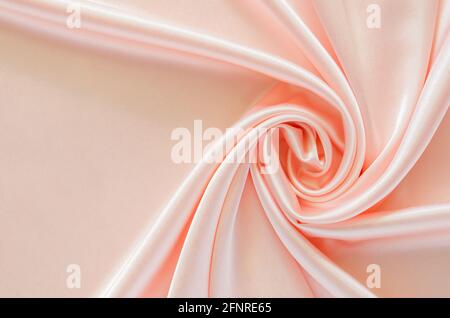Elegant wavy and smooth pink satin cloth texture background. Abstract, texture and wedding concept. Stock Photo